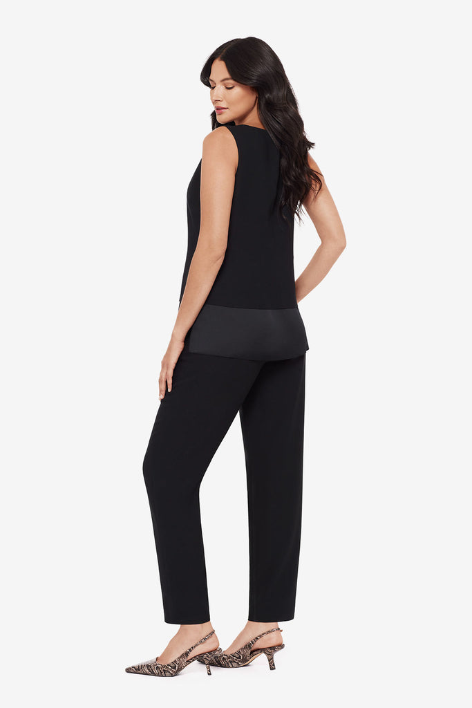Woman turned left wearing a black layered tunic top with matching jogger pants