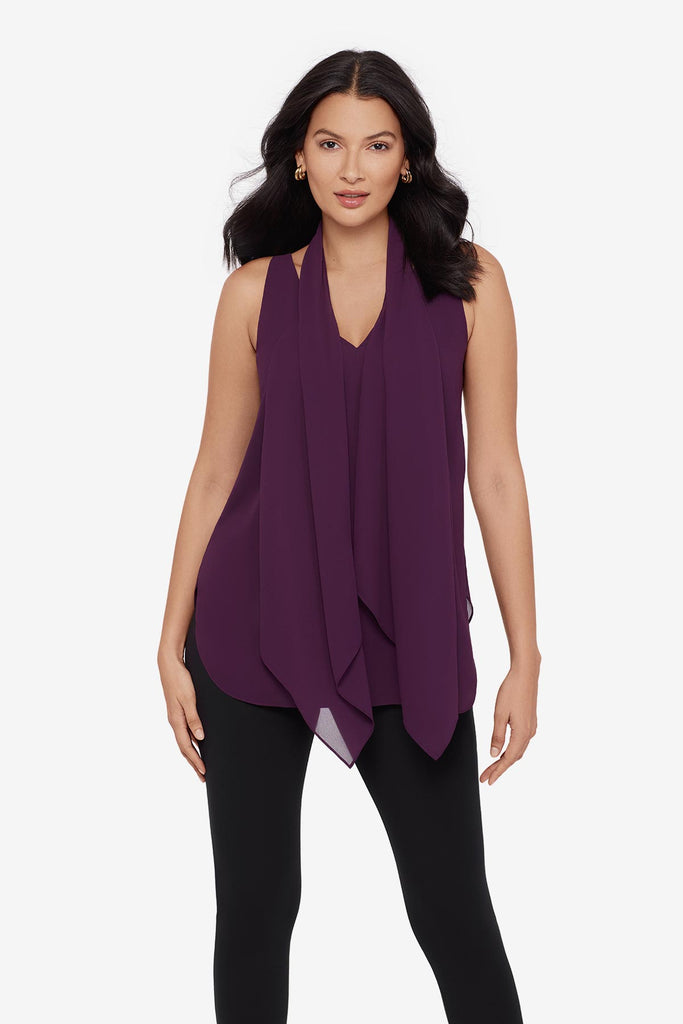 Close up of woman wearing a plum-colored tunic blouse
