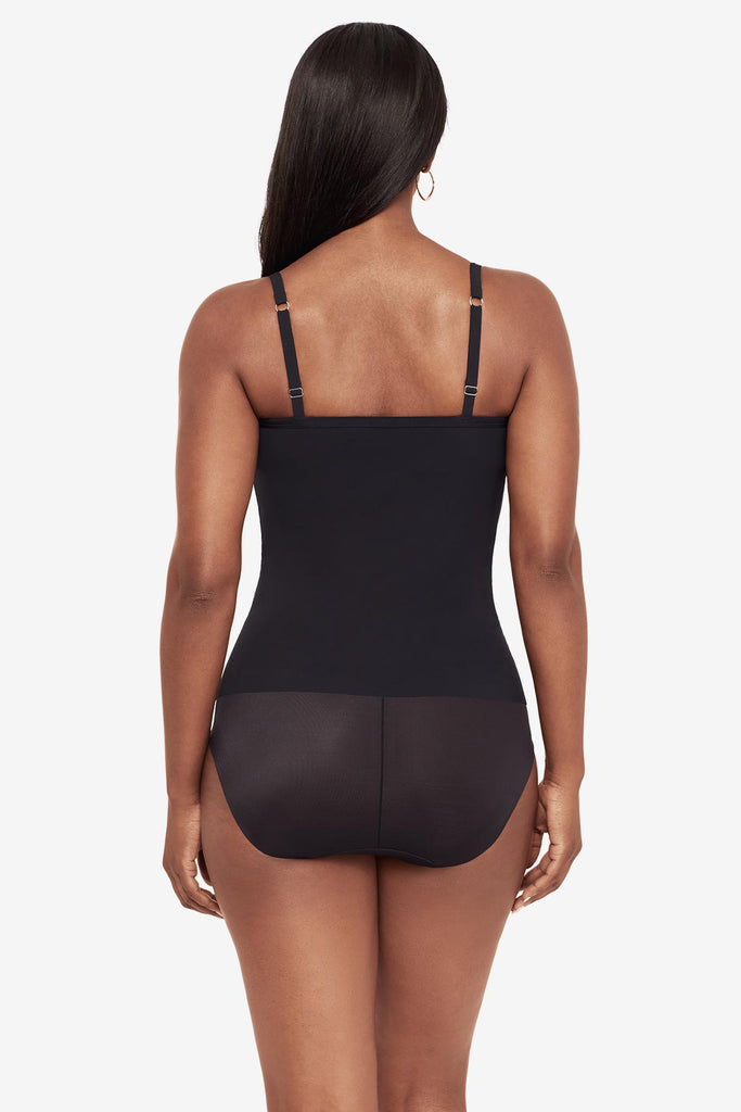 Woman turned away wearing a black cupped bra cami top