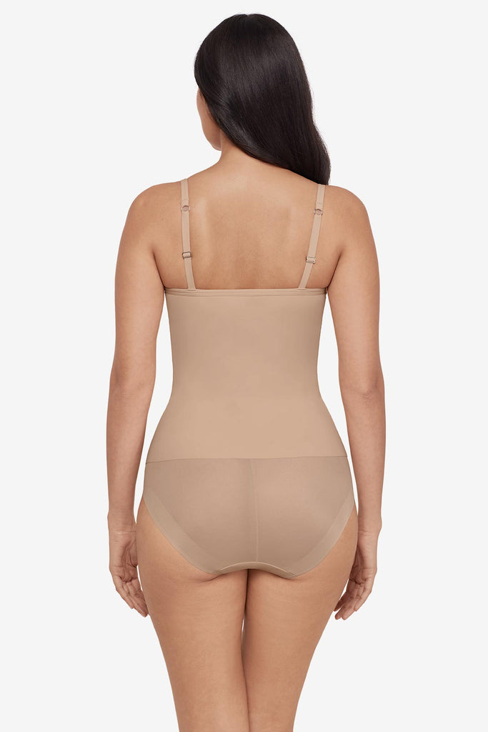 Woman turned away wearing a tan cupped bra cami top