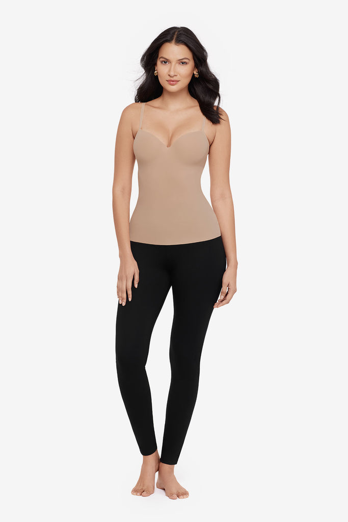 Woman wearing a tan cupped bra cami top with black leggings