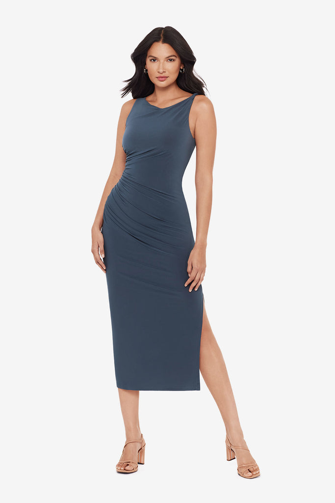Woman wearing a slate grey maxi dress with ruching on the side