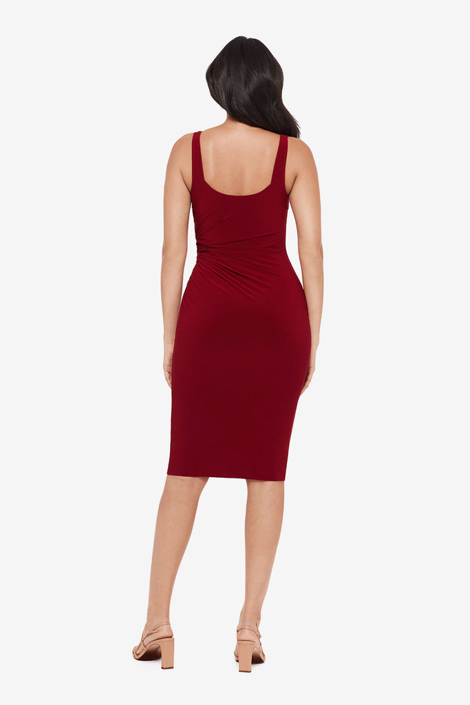 Woman turned away wearing a crimson red midi dress