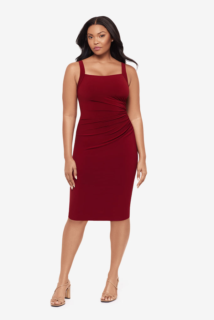 Woman wearing a crimson red midi dress with a square neckline