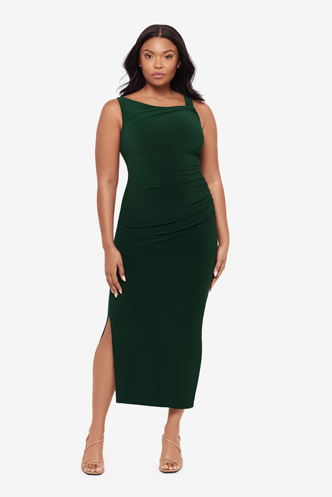 Woman wearing a dark green maxi dress with slits on both sides