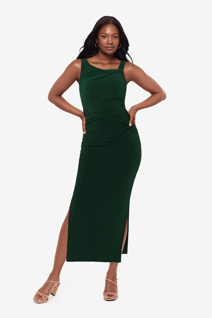 Woman wearing a dark green maxi dress with slits on both sides
