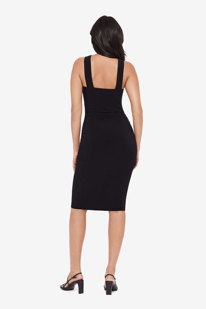Woman turned away wearing a black midi dress