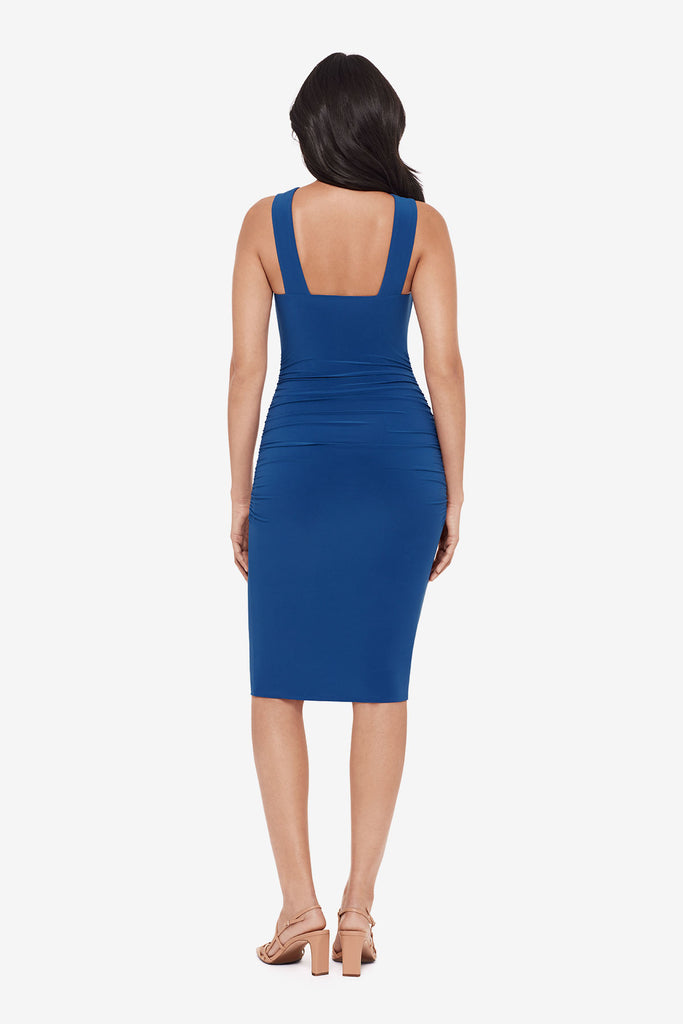 Woman turned away wearing a blue midi dress