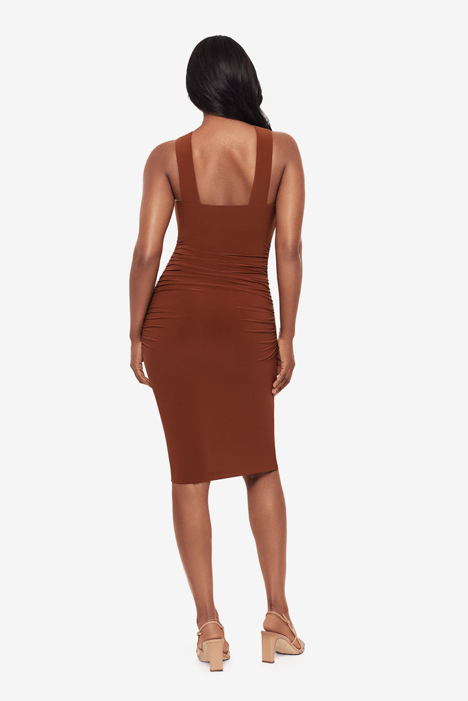 Woman turned away wearing a bronze brown midi dress