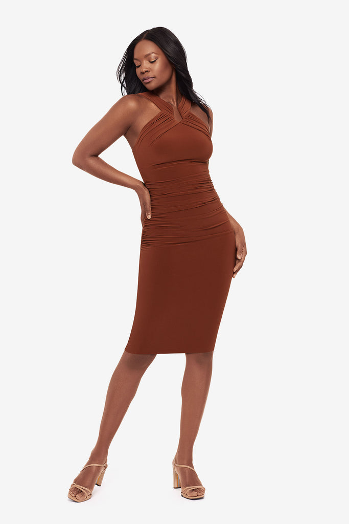 Woman wearing a bronze brown midi dress with a high neckline