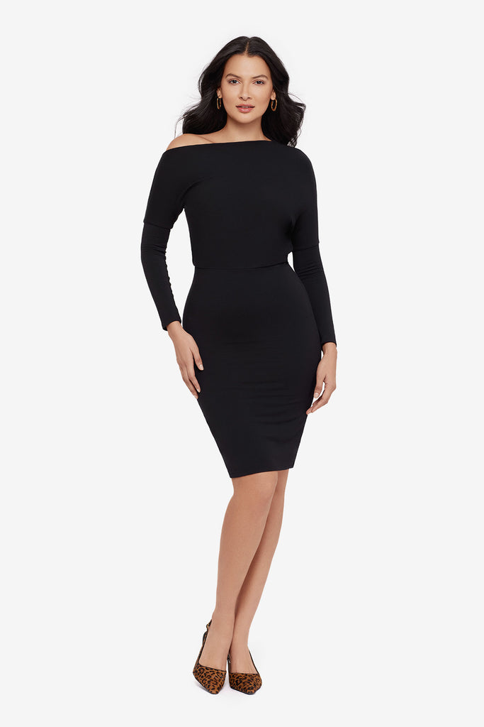 Woman wearing a black long sleeve dress at knee length