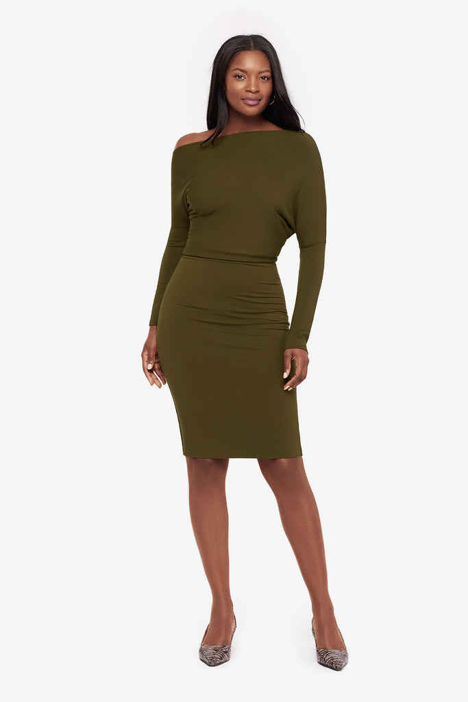 Woman wearing a green long sleeve dress at knee length 