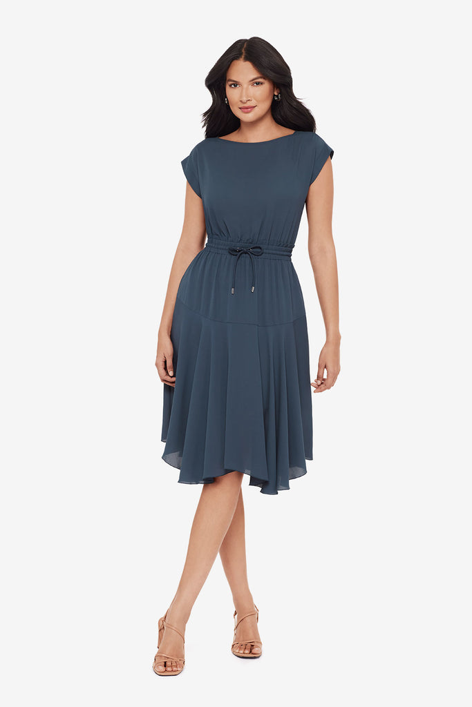 Woman wearing a blue short sleeve dress with a drawstring feature