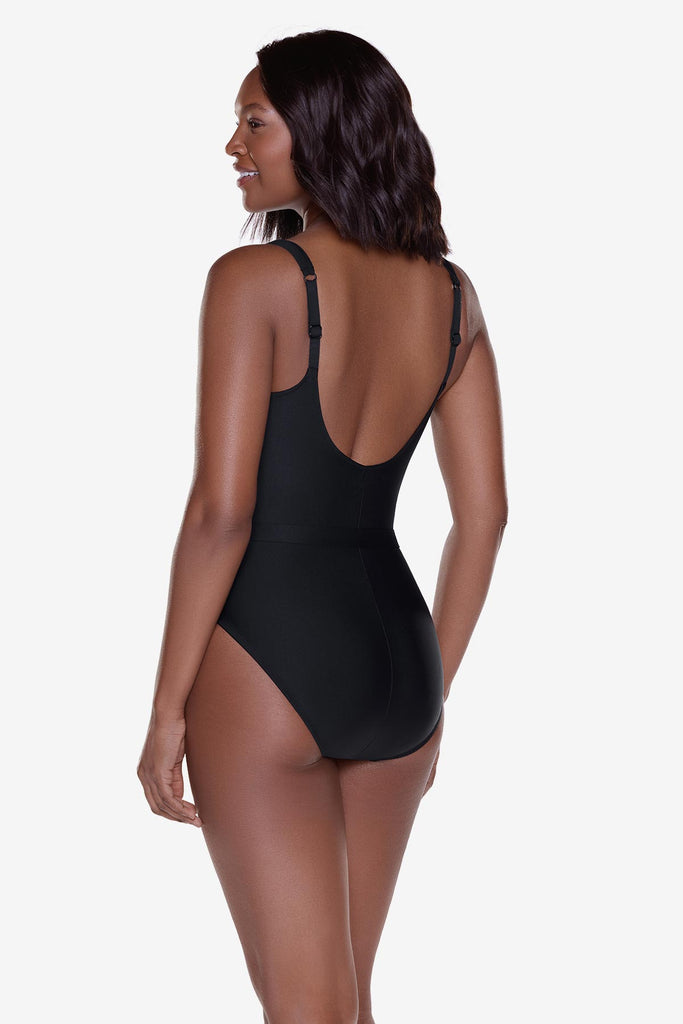 Woman turned left wearing a black one-piece swimsuit with belt detail
