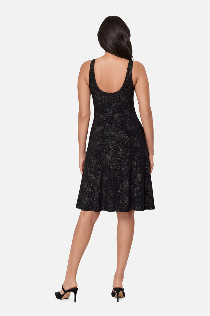Woman turned away wearing a black sparkle printed knee length dress