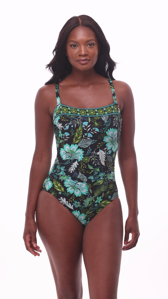 Woman wearing a multicolored floral printed one-piece swimsuit