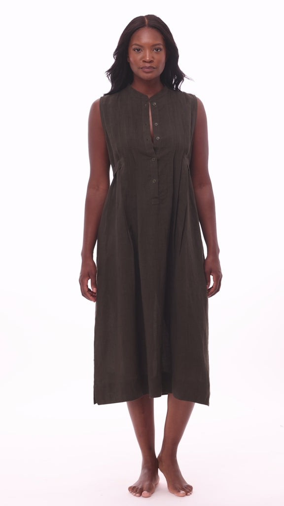 Woman wearing a dark green swim dress cover up
