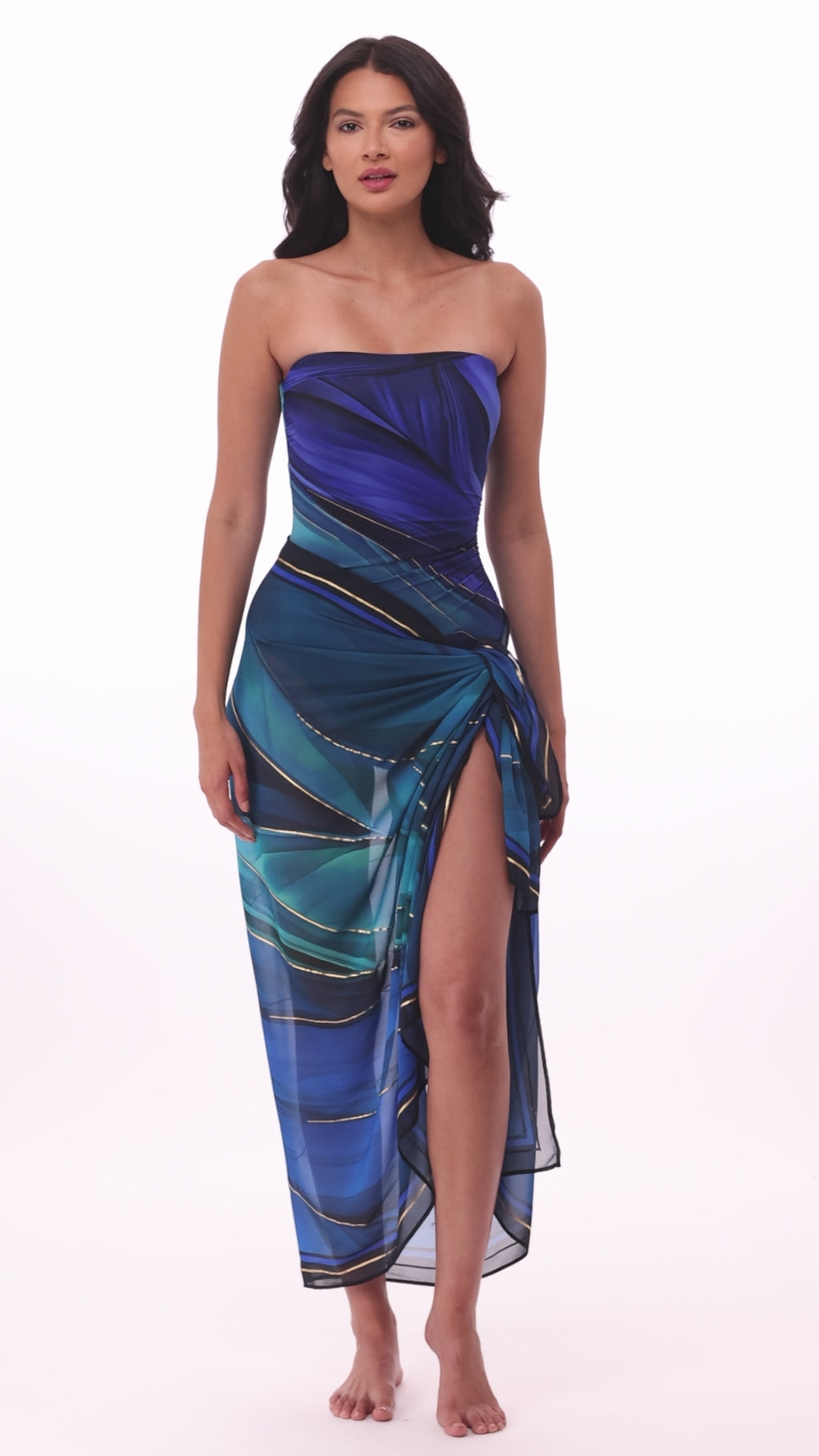 Woman wearing a multi-blue swim cover up with matching swimsuit