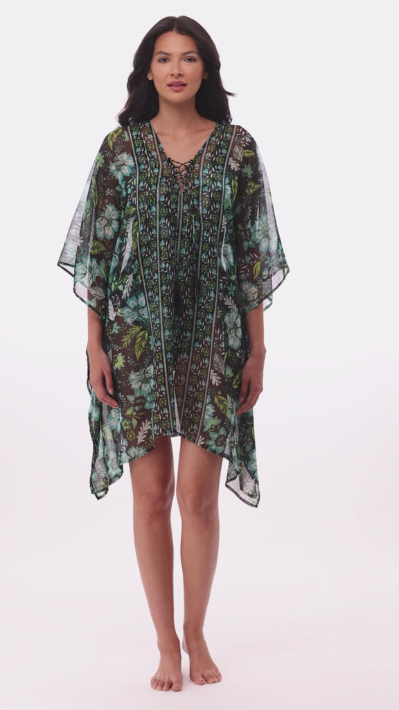Woman wearing a multicolored floral printed catan swim dress cover up