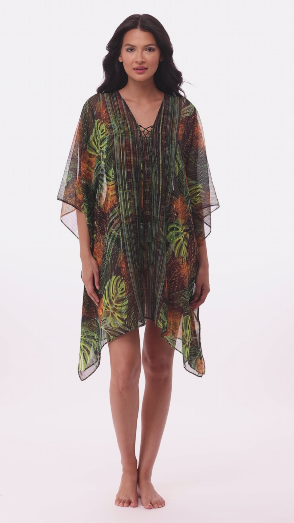 Woman wearing a palm leaf printed caftan swim cover up