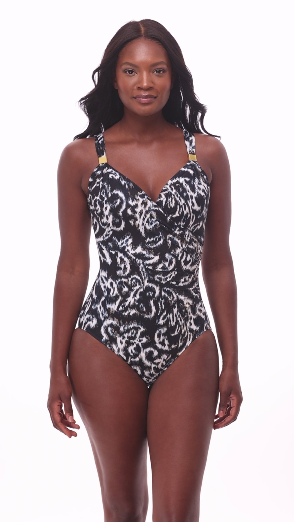 Woman wearing a black and white abstract printed one-piece swimsuit