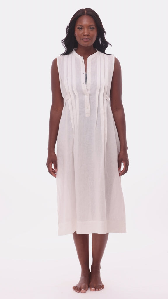 Woman wearing a white swim dress cover up