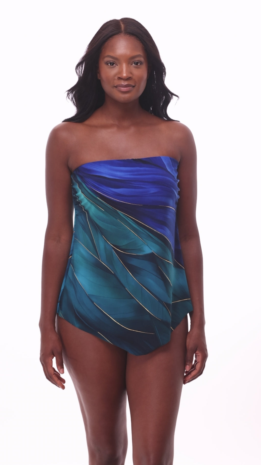 Woman wearing a multi-blue bandeau tankini top with gold detail