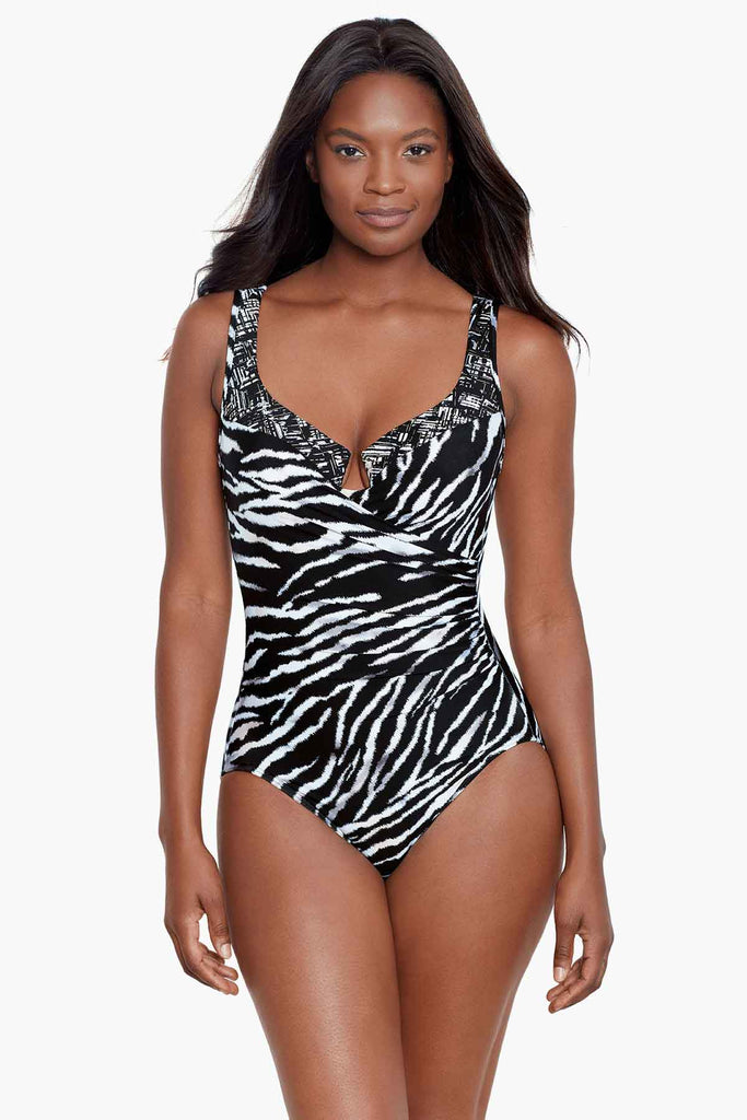 An african american woman wearing a black and white printed swimming costume.