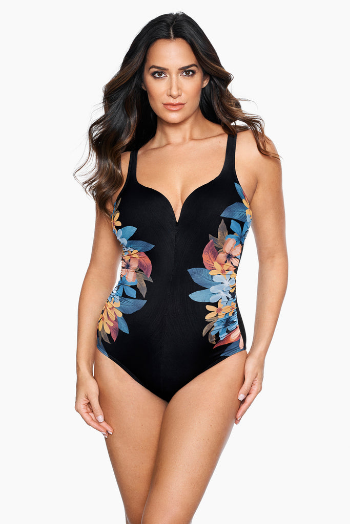 Woman wearing a printed one piece swim suit.