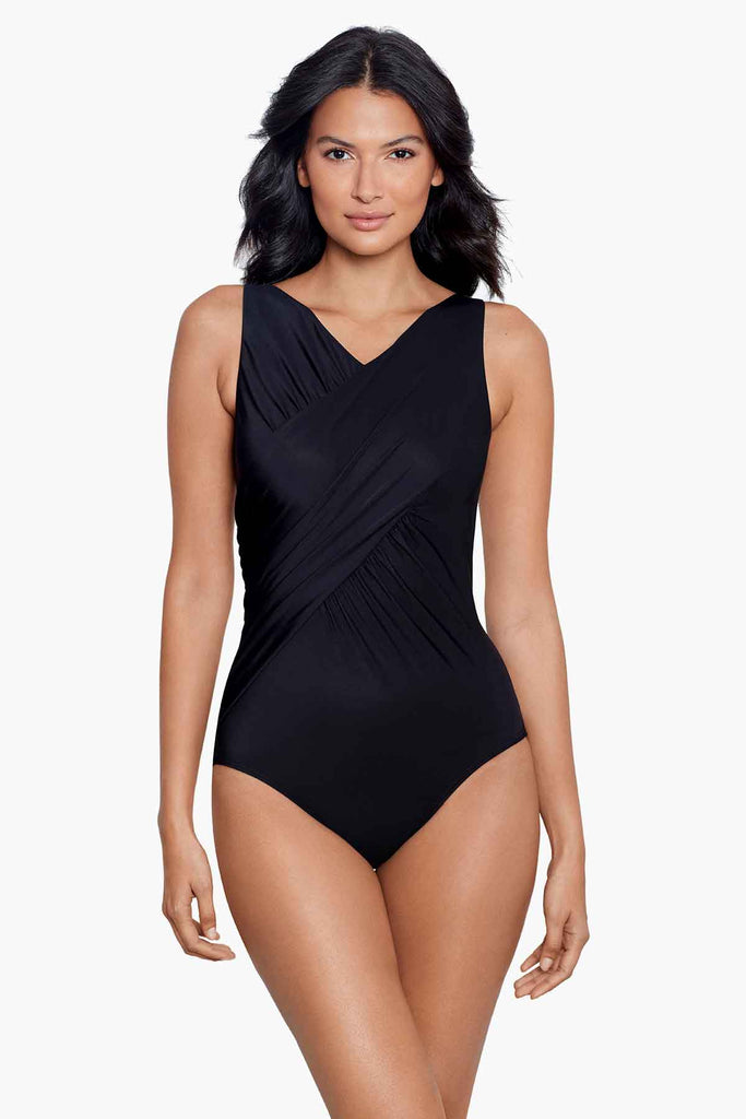A slender woman wearing a one piece swim suit.
