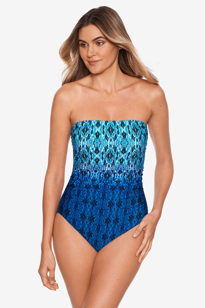 Woman in a miracle suit bandeau one piece swim suit.